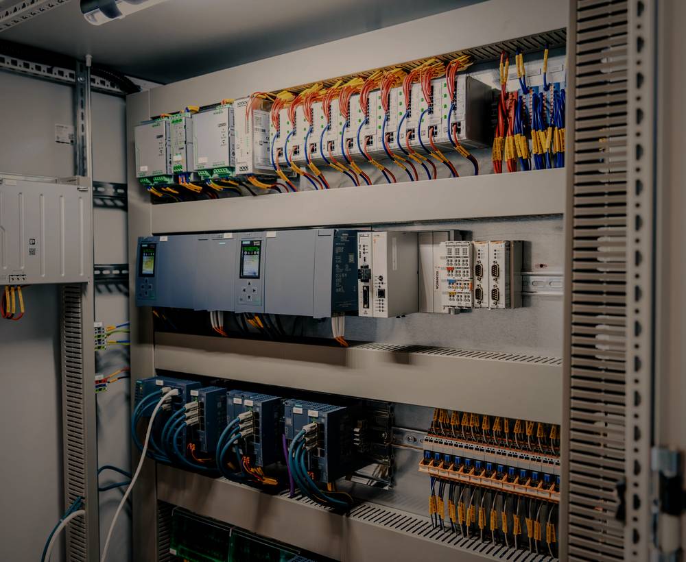 Neatly terminated control panel with orange wiring looms